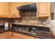Kitchen has sleek steel hood vent matching the stainless steel cooktop and granite countertops at 6887 E Hacienda La Colorada Dr, Gold Canyon, AZ 85118