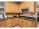 Kitchen boasts wood cabinets, granite counters, stainless steel appliances and tile backsplash at 6887 E Hacienda La Colorada Dr, Gold Canyon, AZ 85118