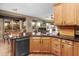 Open kitchen with wood cabinets, black appliances, a breakfast bar and open to the living area at 6887 E Hacienda La Colorada Dr, Gold Canyon, AZ 85118