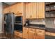 Kitchen has stainless appliances, granite counters, wood cabinets and open shelving at 6887 E Hacienda La Colorada Dr, Gold Canyon, AZ 85118