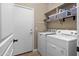Bright laundry room with washer, dryer, door, and shelving at 6887 E Hacienda La Colorada Dr, Gold Canyon, AZ 85118