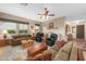 Comfortable living room with sofas, ceiling fan, neutral color paint, and multiple windows at 6887 E Hacienda La Colorada Dr, Gold Canyon, AZ 85118