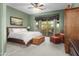 Bright main bedroom featuring a ceiling fan and sliding glass doors to the patio at 6887 E Hacienda La Colorada Dr, Gold Canyon, AZ 85118