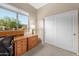 Bright office space with a built-in desk, cabinets and a view of the outdoors at 6887 E Hacienda La Colorada Dr, Gold Canyon, AZ 85118