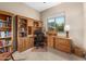 Home office with built-in bookshelves, desk and natural light at 6887 E Hacienda La Colorada Dr, Gold Canyon, AZ 85118