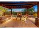 Inviting outdoor living area featuring a stone fireplace, comfortable seating, and a pergola at 6887 E Hacienda La Colorada Dr, Gold Canyon, AZ 85118