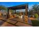Outdoor patio with fireplace, built in seating, pergola and beautiful hardscape at 6887 E Hacienda La Colorada Dr, Gold Canyon, AZ 85118