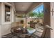 Covered patio with seating area and view of landscaped backyard with desert vegetation at 6887 E Hacienda La Colorada Dr, Gold Canyon, AZ 85118