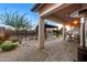 Extended covered patio with comfortable seating and landscaped backyard at 6887 E Hacienda La Colorada Dr, Gold Canyon, AZ 85118