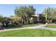 Community pool entrance features a grassy lawn, desert landscaping, and secure fencing at 6887 E Hacienda La Colorada Dr, Gold Canyon, AZ 85118