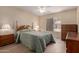 Cozy bedroom features wood furniture, a ceiling fan, and a window with natural light at 1021 S Greenfield Rd # 1194, Mesa, AZ 85206
