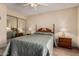 Bedroom features wood floors, closet with mirror doors, and two bedside tables with lamps at 1021 S Greenfield Rd # 1194, Mesa, AZ 85206