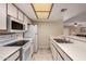 Kitchen featuring white appliances and cabinets, tile flooring, and breakfast bar area at 1021 S Greenfield Rd # 1194, Mesa, AZ 85206