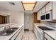 Kitchen featuring white appliances and cabinets, tile flooring, and stainless steel sink at 1021 S Greenfield Rd # 1194, Mesa, AZ 85206