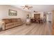 Living room and dining room with wood floors, large couch, and traditional dining set at 1021 S Greenfield Rd # 1194, Mesa, AZ 85206