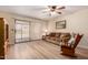 Relaxing living room with wood floors, ceiling fan, and sliding doors to the backyard at 1021 S Greenfield Rd # 1194, Mesa, AZ 85206