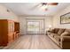 Spacious living room features wood flooring, sliding glass door to patio, and ceiling fan at 1021 S Greenfield Rd # 1194, Mesa, AZ 85206