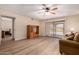 Living room features wood flooring, sliding glass door to patio, and doorway to bedroom at 1021 S Greenfield Rd # 1194, Mesa, AZ 85206