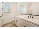 Bright bathroom featuring a white vanity, modern fixtures, and a window offering natural light at 14742 W Lariat Trl, Surprise, AZ 85387