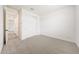Cozy bedroom with neutral carpet, ample closet space, and a well-lit hallway entrance at 14742 W Lariat Trl, Surprise, AZ 85387
