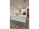 Bright kitchen boasts large island, modern appliances, white cabinets, and sleek design at 14742 W Lariat Trl, Surprise, AZ 85387