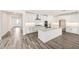 Well-appointed kitchen featuring a large island, white cabinets, and stainless steel appliances at 14742 W Lariat Trl, Surprise, AZ 85387