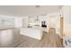 Open-concept kitchen with white cabinets, large island, and modern appliances at 14742 W Lariat Trl, Surprise, AZ 85387