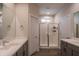 Bright bathroom featuring double sinks and a glass-enclosed shower for a modern and functional design at 2030 E Michigan Ave # 4, Phoenix, AZ 85022