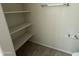 Small bathroom or toilet room featuring three shelves for storage and tiled flooring at 3021 N 306Th Ln, Buckeye, AZ 85396