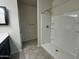 Clean bathroom featuring a shower, neutral color scheme, and tiled floors at 3021 N 306Th Ln, Buckeye, AZ 85396