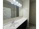 Bathroom with a black vanity, white sink, large mirror, and recessed lighting, ready for personalization at 3021 N 306Th Ln, Buckeye, AZ 85396