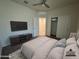 Modern staged bedroom with a large TV, carpeted floors, and closet for ample storage at 3021 N 306Th Ln, Buckeye, AZ 85396