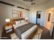 Staged bedroom with floating shelves, a closet, wood bed frame, and neutral color palette at 3021 N 306Th Ln, Buckeye, AZ 85396