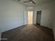 Spacious bedroom with ceiling fan, closet, and neutral carpeting at 3021 N 306Th Ln, Buckeye, AZ 85396