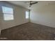 Bedroom with carpet, multiple windows, and a ceiling fan at 3021 N 306Th Ln, Buckeye, AZ 85396
