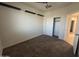 A vacant bedroom featuring neutral carpet, a window, closet and an ensuite bathroom at 3021 N 306Th Ln, Buckeye, AZ 85396