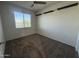 Empty bedroom with neutral carpet, a window with blinds, and floating shelves for customization at 3021 N 306Th Ln, Buckeye, AZ 85396