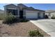 Well-maintained front exterior of the home with a three car garage and desert landscaping at 3021 N 306Th Ln, Buckeye, AZ 85396