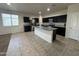 Well-lit kitchen showcasing granite countertops, stainless steel appliances, and an island with seating at 3021 N 306Th Ln, Buckeye, AZ 85396