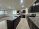 Open floorplan in this home boasts kitchen with large island that is perfect for entertaining guests at 3021 N 306Th Ln, Buckeye, AZ 85396