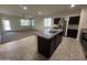 Spacious open floorplan boasts a modern kitchen island and easy access to your dining room and living room at 3021 N 306Th Ln, Buckeye, AZ 85396