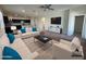 Open-concept living room features stylish furniture, a ceiling fan, and seamless flow to the kitchen at 3021 N 306Th Ln, Buckeye, AZ 85396