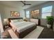 Comfortable main bedroom with a ceiling fan, ample natural light, and stylish decor at 3021 N 306Th Ln, Buckeye, AZ 85396