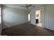 Spacious main bedroom showing carpet, natural light, and a view to the ensuite bathroom at 3021 N 306Th Ln, Buckeye, AZ 85396