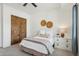 Simple bedroom features a bed, nightstand, and closet with carpet flooring and neutral walls at 7701 E Golden Eagle Cir, Gold Canyon, AZ 85118