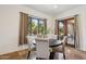 Charming dining area features a round table with upholstered chairs and a view to the outdoor courtyard at 7701 E Golden Eagle Cir, Gold Canyon, AZ 85118