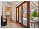 The hallway provides access to the living room and patio area and features tiled floors at 7701 E Golden Eagle Cir, Gold Canyon, AZ 85118