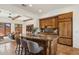 Spacious kitchen with granite island, wooden cabinetry, and open layout to the living room at 7701 E Golden Eagle Cir, Gold Canyon, AZ 85118