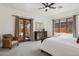 Bright main bedroom features a ceiling fan, outside access, and neutral-colored walls and carpeting at 7701 E Golden Eagle Cir, Gold Canyon, AZ 85118