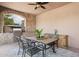 Covered patio with outdoor dining area featuring a stone archway and a built-in BBQ grill at 7701 E Golden Eagle Cir, Gold Canyon, AZ 85118